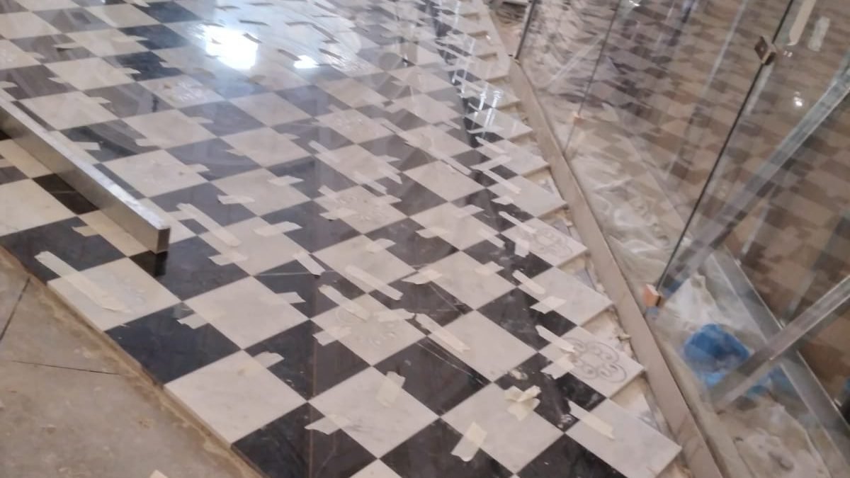 Marble chequerboard flooring during installation at Bacha Coffee, Villagio