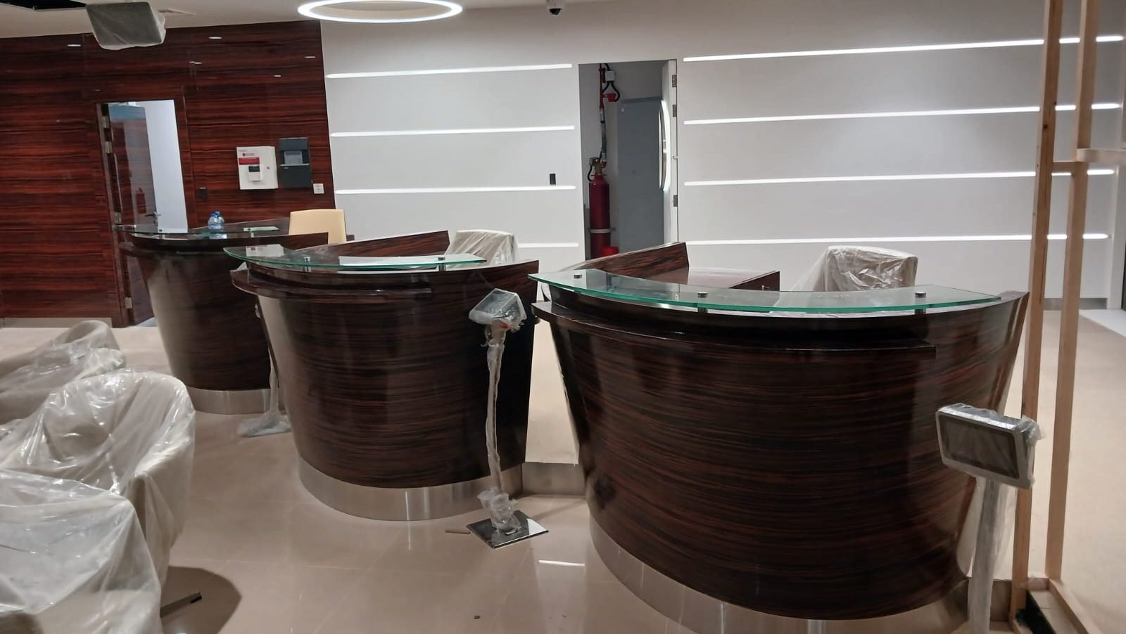 Curved timber teller counters under construction at the bank fit-out in Doha, Al Khor