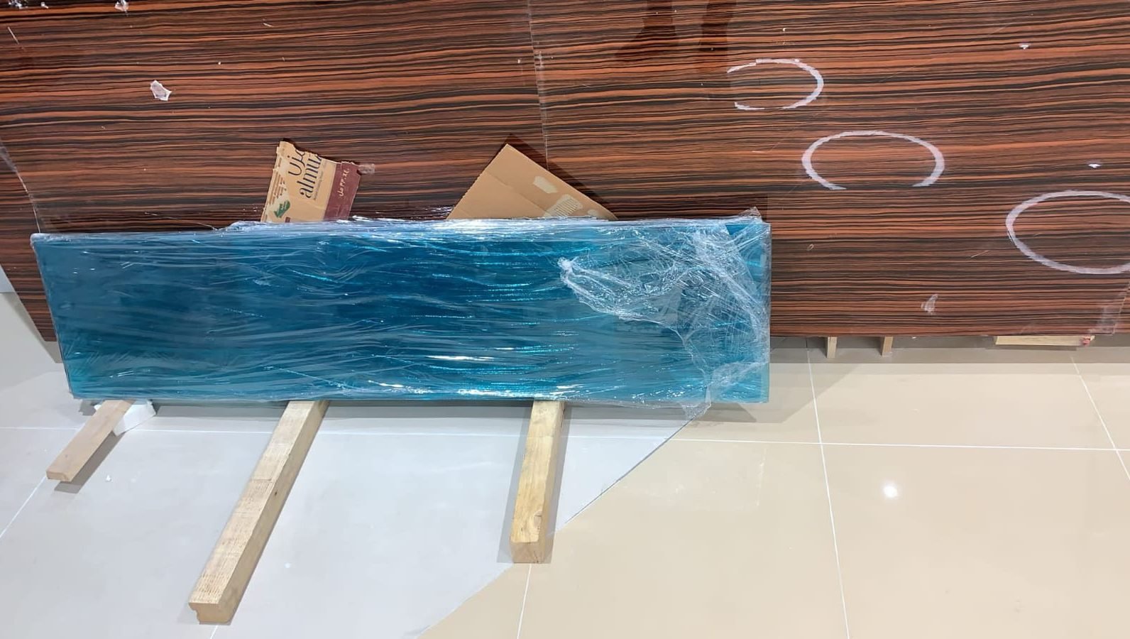 Protected backlit glass feature panel ready for installation at the Doha Al Khor bank fit-out