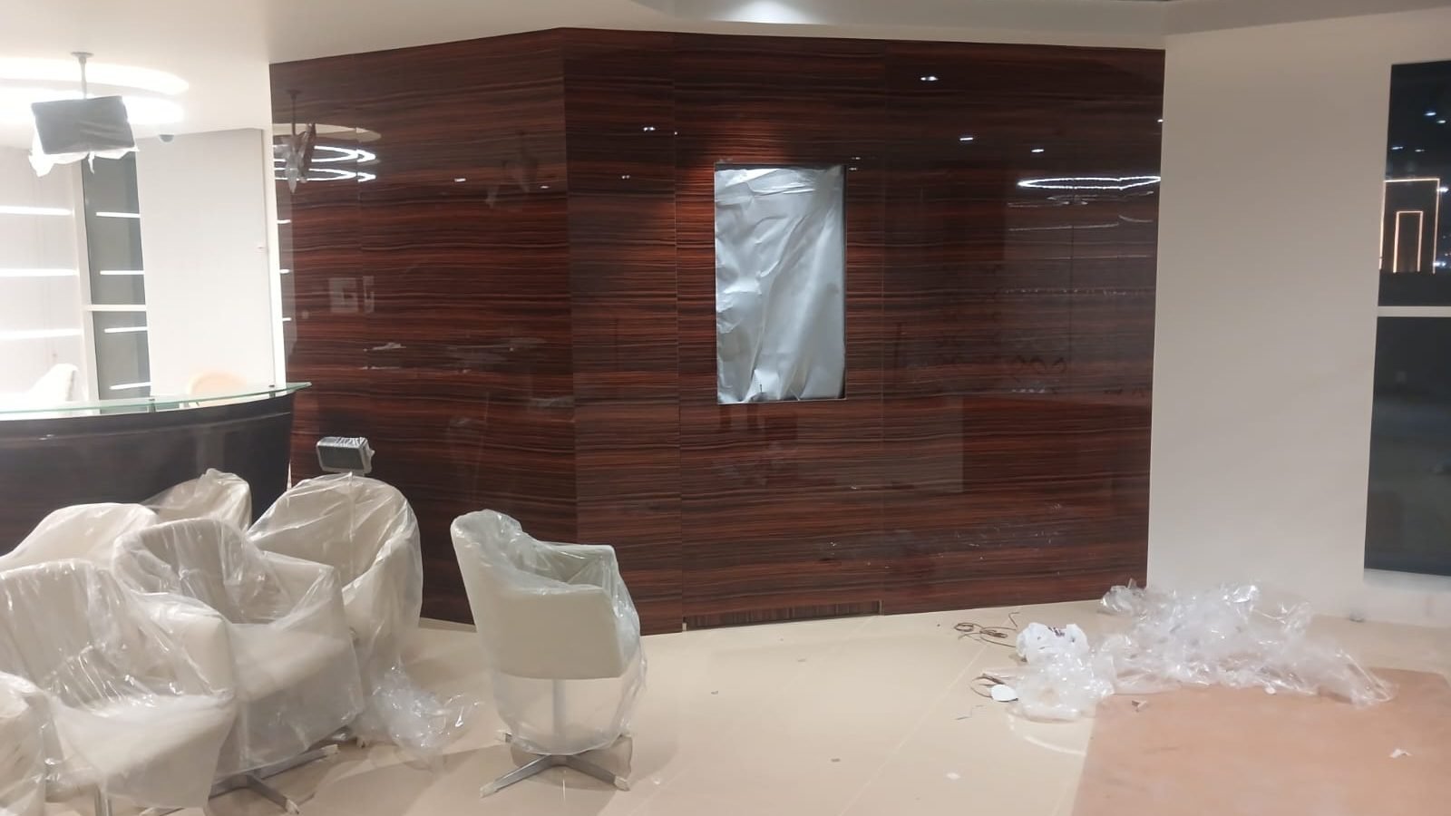 Bank waiting area with timber wall panelling and armchairs, Doha Al Khor