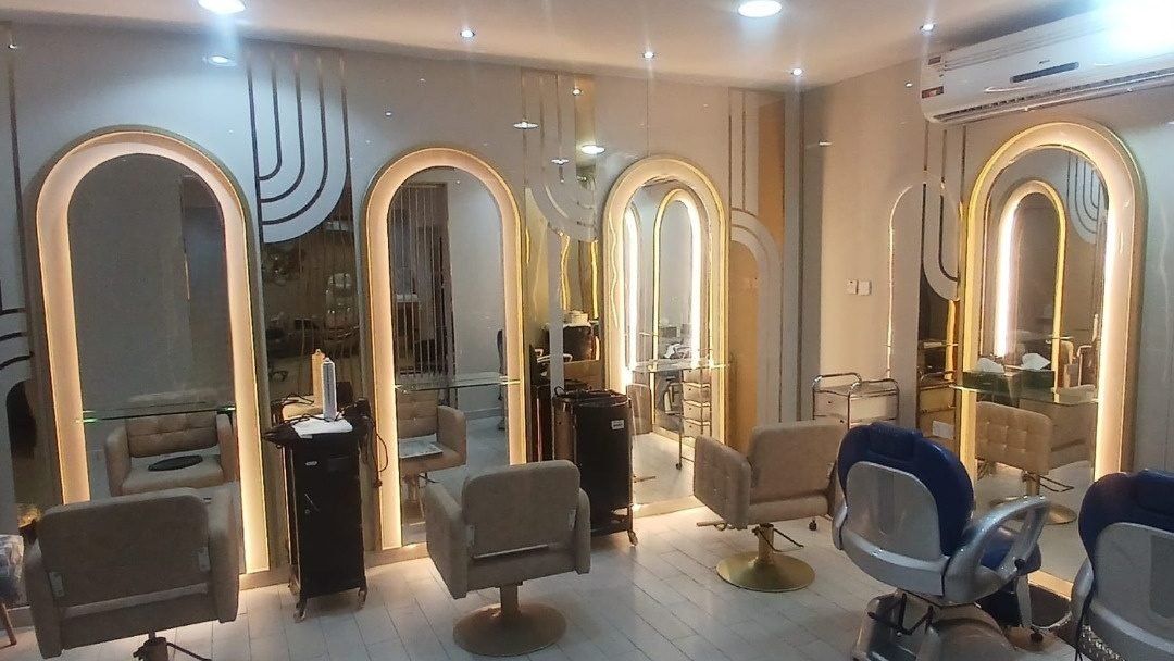 Finished salon interior with arched mirrors and gold detailing, Al Massa beauty center Doha