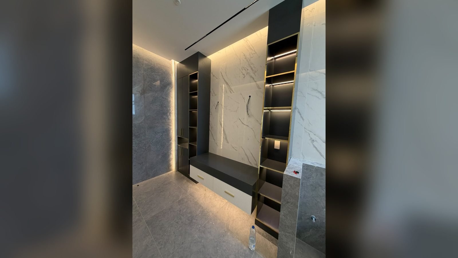 Illuminated display joinery and shelving with marble detailing in Qatar