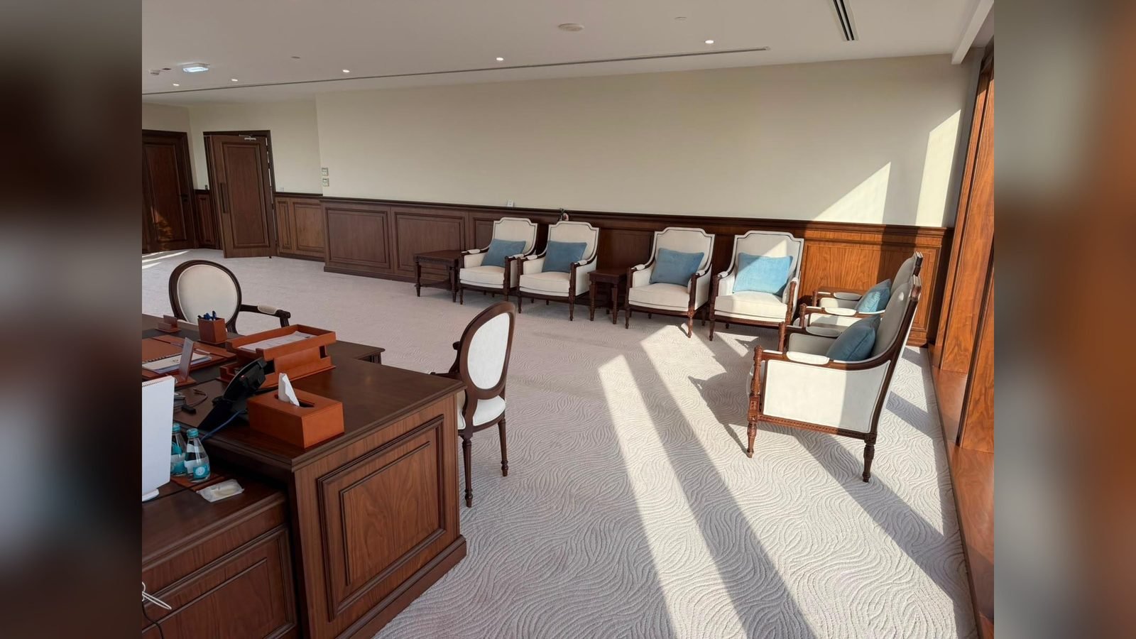 Executive lounge fit-out in Doha with timber desk, panelling and upholstered seating