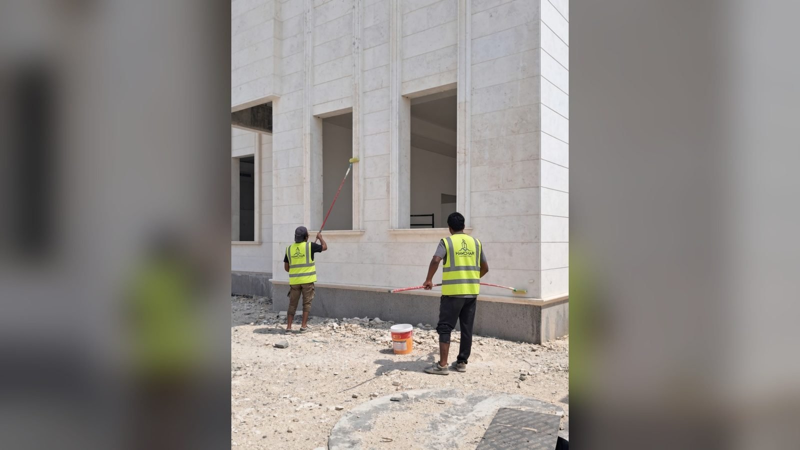 Hawchar Contracting site team finishing a building facade in Doha