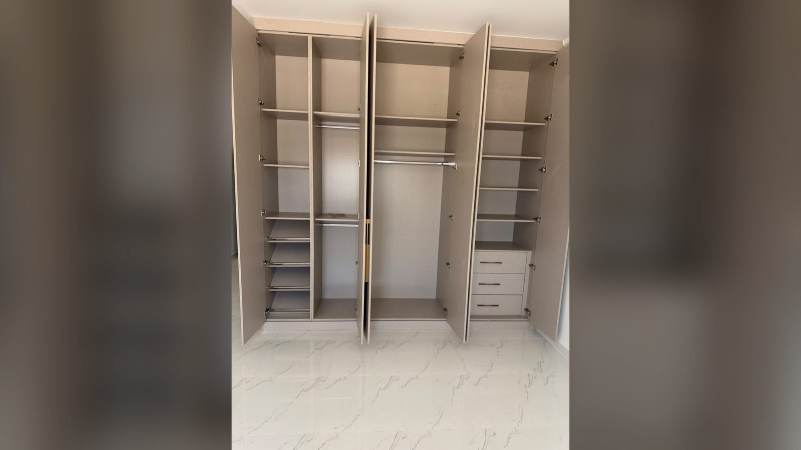 Fitted wardrobe interior with shelving and drawers, joinery work in Doha