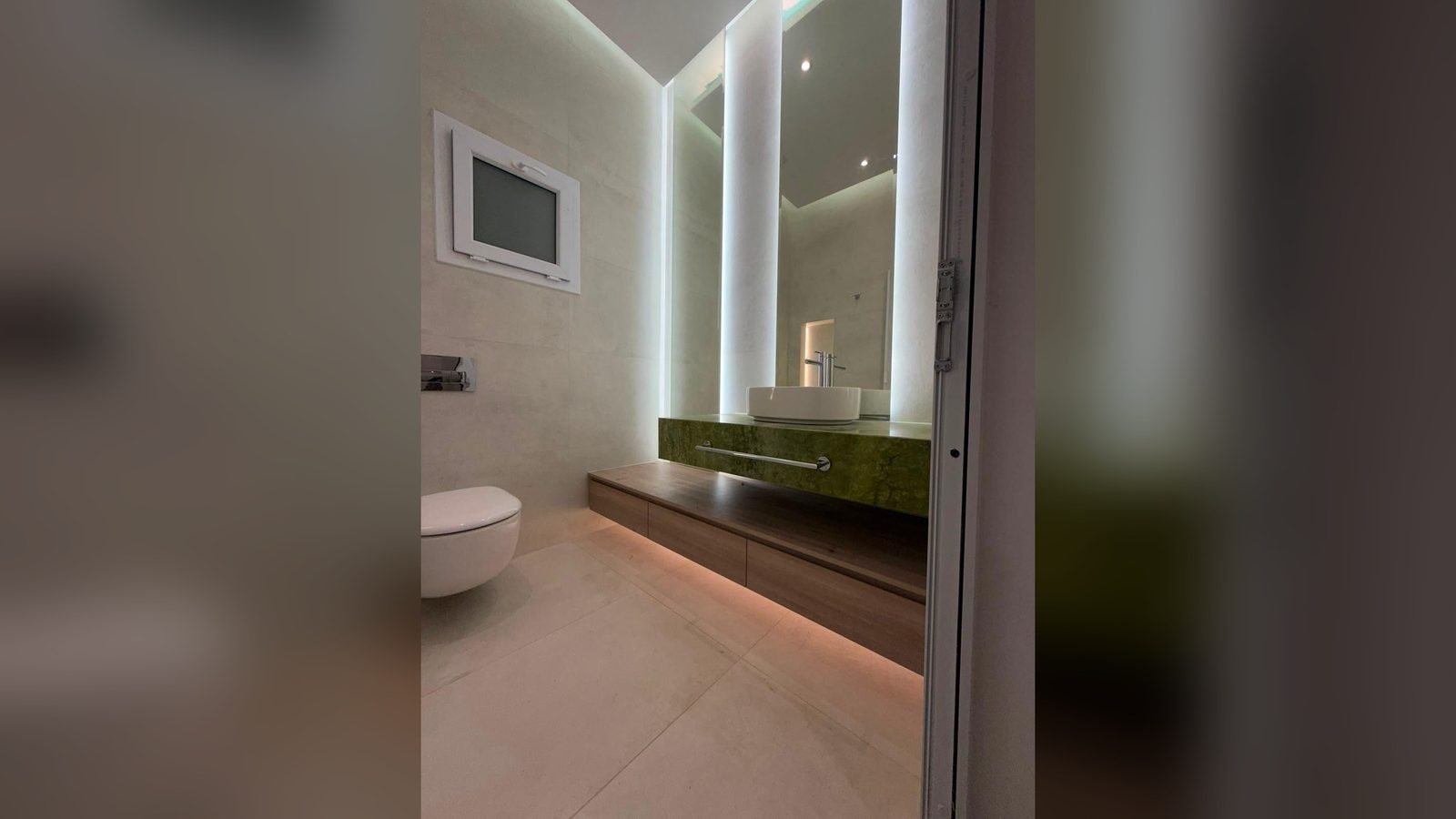 Marble bathroom fit-out in Qatar including shower installation and stone wall cladding