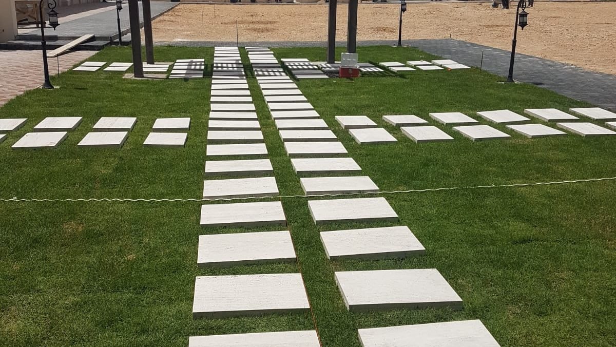 Stone stepping-stone pathway and lawn landscaping at the Al Anayze private villa in Qatar