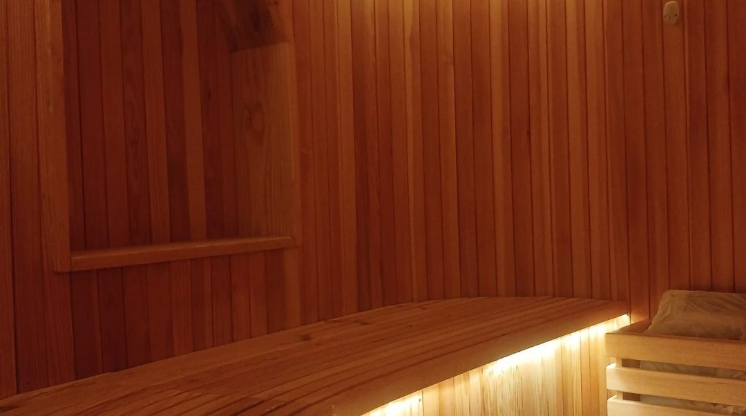 Cedar-lined sauna cabin with concealed lighting at St. Regis Al Mouj Muscat