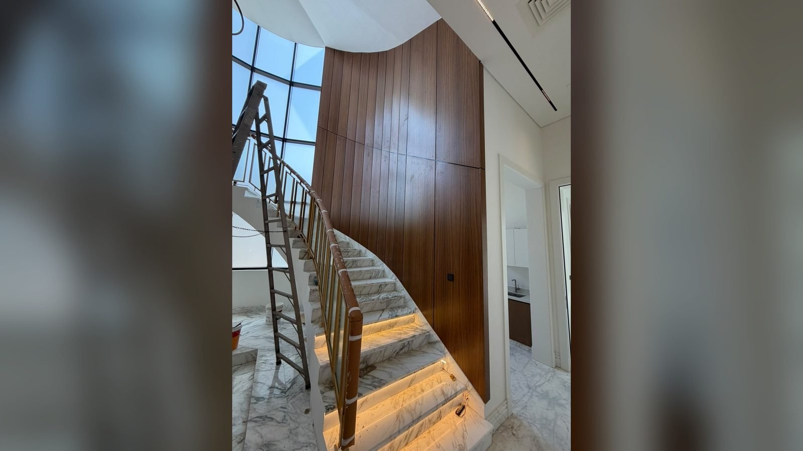 Timber staircase and curved wall joinery in a Doha villa interior fit-out